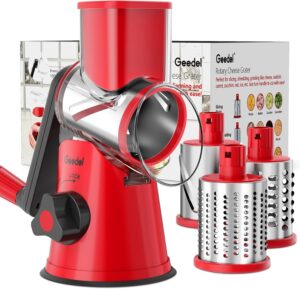 Geedel rotary cheese grater with three interchangeable stainless steel blades on a white kitchen counter.