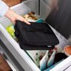 A close-up view of the ECOFREEZE technology built directly into the walls of the black lunch cooler.