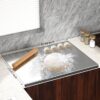 Large titanium cutting board with 2cm bending design to securely grip the edge of a kitchen workspace