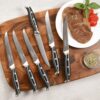 Full 16-piece Damascus knife set featuring steak knives and meat fork
