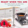 A person using the Dash cordless immersion blender to puree hot soup directly in a cooking pot