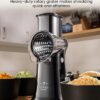 The Zulay Kitchen rotary cheese grater with its compact storage box for organized kitchen cabinet storage.