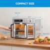 Lifestyle shot showing the Midea Flexify French door air fryer toaster oven preparing a family-sized meal.