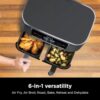Action shot of the Ninja 8 quart dual basket air fryer cooking a main and side dish simultaneously.