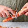 Side profile of the Milk Street stainless steel vegetable peeler highlighting its durable Y-peeler construction.