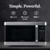 The Farberware 1.6 cu ft countertop microwave door open to show the spacious interior cavity.
