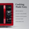 Detailed shot of the child safety lock button on the metallic red Farberware microwave oven.
