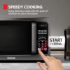 Toshiba compact microwave oven showing the bright LED interior lighting during operation