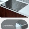 Professional kitchen setup showcasing the TaiSENtric large titanium cutting board as a protective splash guard