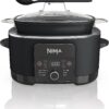 Ninja PossibleCooker PLUS 12-in-1 multi cooker in black sitting on a modern kitchen countertop