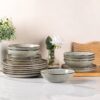 Complete 24-piece AmorArc ceramic dinnerware set for 8 arranged on a modern dining table.