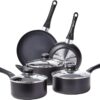 Full 8-piece Amazon Basics ceramic non-stick cookware set in black arranged on a kitchen counter.