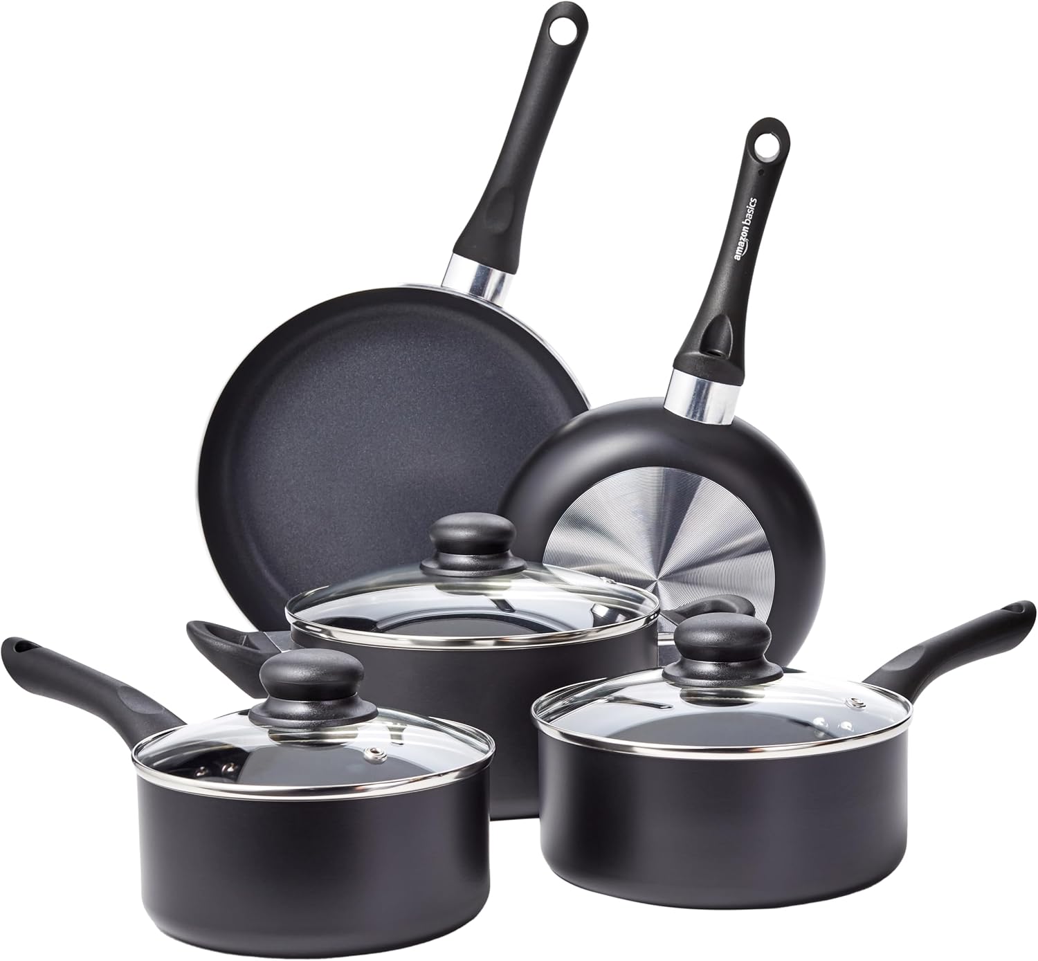 Full 8-piece Amazon Basics ceramic non-stick cookware set in black arranged on a kitchen counter.