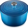 Le Creuset 6.5qt deep enameled cast iron dutch oven in vibrant Marseille blue on a stovetop.