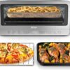Ninja Flip toaster oven air fryer flipped up against a kitchen backsplash to save 50% counter space.