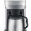 Breville Grind Control coffee maker with grinder in brushed stainless steel finish on a modern kitchen counter.