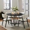 Full view of the NUTIKAS 42 inch round dining table showing its circular silhouette and industrial metal legs.
