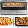 Front view of the Ninja 8-in-1 flip toaster oven air fryer in a modern stainless steel kitchen.