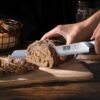 Ergonomic Pakkawood handle of the HOSHANHO bread knife designed for a comfortable and stable grip.