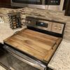 Stylish acacia wood noodle board serving as a charcuterie tray on a dining table