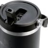 Side view of the black Stanley IceFlow flip straw tumbler sitting in a car cupholder for commute.