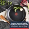 Detail view of the Thermo-Spot heat indicator on a T-Fal nonstick skillet, turning red when preheated.