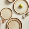 A full 24-piece ceramic dinnerware set arrangement including 10-inch dinner plates, salad plates, and cereal bowls.
