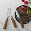 Elegant flat lay of the 6-piece serrated steak knife set showcasing natural ash wood grain handles