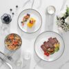 A modern table setting featuring the 12 piece porcelain dinnerware set including dinner plates and cereal bowls.