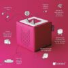 Included charging station and pink Toniebox, a perfect screen-free audio player for kids bedside.