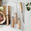 Ergonomic ash wood handle detail of the 8-piece steak knife set showing the unique, natural wood grain pattern.