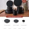 Modern matte black stoneware plates stacked neatly to demonstrate space-saving design in a cupboard.