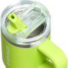 A 14oz Stanley flip straw tumbler held in hand to showcase its compact, car-cup-friendly base