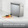 A 12-inch pizza baking inside the Ninja flip toaster oven air fryer showing large interior capacity.