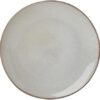 Side angle shot of a stoneware dinner plate and bowl showcasing the nature-inspired organic shapes.