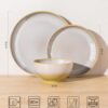 Stackable design of TheTerra ceramic dinnerware set showing space-saving storage in a cabinet.