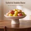 Styled minimalist living room decor featuring the beige travertine fruit bowl on a coffee table.