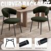 Close-up of the rotating adjustable footpad on the black metal leg of the boucle dining chair