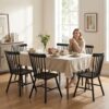 Side view of the armless black dining chair design that slides easily under tables to save space.