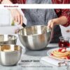 Detail view of the sturdy rim on a KitchenAid stainless steel mixing bowl designed for easy handling.