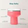 Lifestyle shot of the REDUCE Saltini insulated margarita tumbler being used outdoors at a pool party.