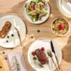 Overhead view of the 12-piece ceramic dinnerware set for 4, including dinner plates, salad plates, and bowls.