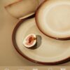 Durable ceramic bowls from the Pokini dinnerware set being used for a casual home meal.