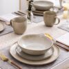 AmorArc ceramic dinnerware set for 8 in a casual home dining setup with bowls and plates.