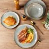 Lead-free, pro-grade stoneware bowls and plates displayed in a kitchen setting to show everyday utility.