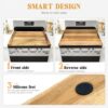 An acacia wood noodle board covering a stovetop to create more usable workspace in a small kitchen