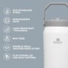 The 64 oz insulated water jug placed in a gym setting, highlighting its 6-day ice retention capacity.