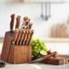 Side view of the Senken Dynasty kitchen knives arranged in their natural acacia storage block.