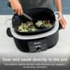 The Ninja PossibleCooker PLUS pot being placed into an oven for high-heat finishing up to 500 degrees