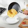 The Amazon Basics black ceramic cookware set pieces stacked neatly to display the compact design.
